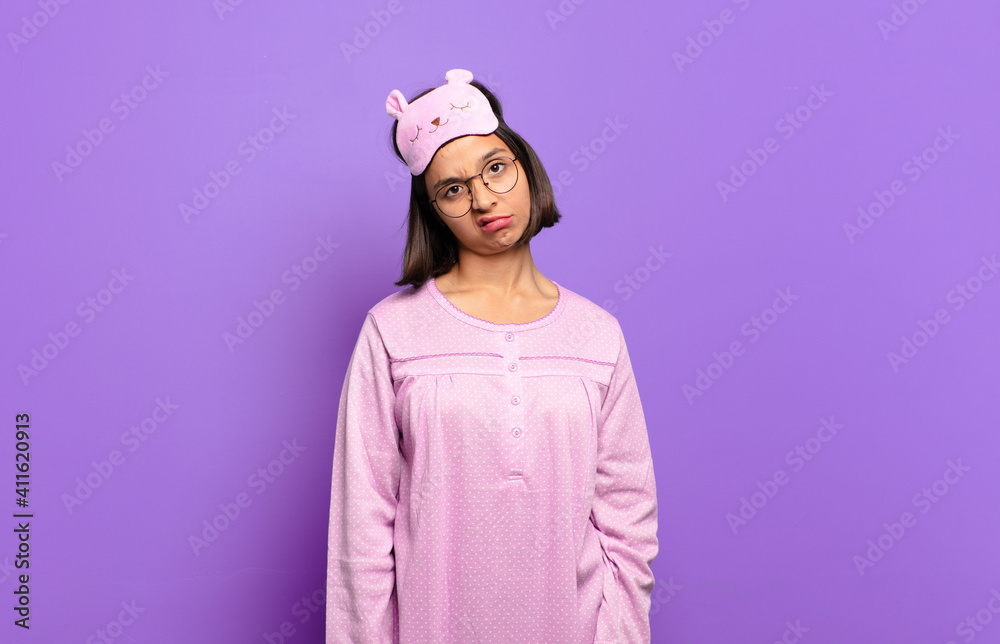 Canvas Prints young hispanic woman feeling puzzled and confused, with a dumb, stunned expression looking at something unexpected