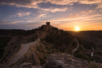 Landscape with the fortified city of Alarcon with the castle on top of the hill at sunset, Cuenca, Spain