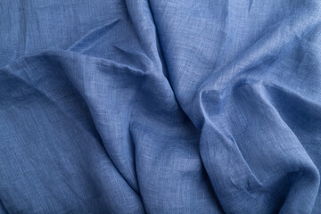 Fragment of blue linen tissue. Top view, natural textile background.