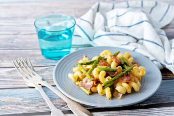 Fried Bacon roasted asparagus pasta in a plate