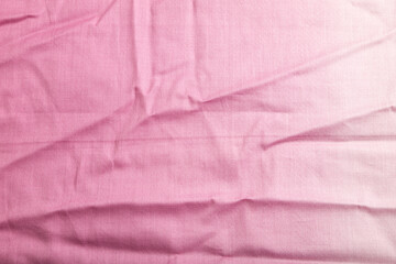 Fragment of smooth cotton purple tissue. Top view, natural textile background.