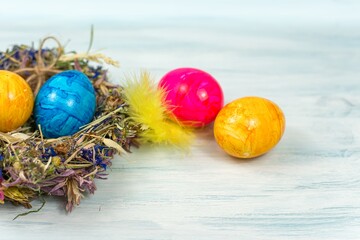 Fototapeta na wymiar happy Easter, different color egg in the nest
