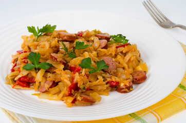 Stewed vegetables, cabbage, paprika with sausages