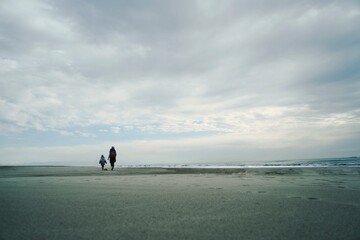 Two are walking along the seashore. Adriatic sea, beach.