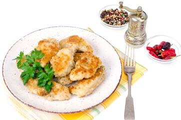 Breaded chicken fillet pieces on plate