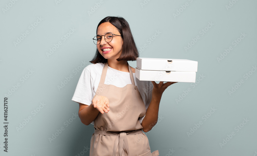 Canvas Prints young hispanic woman smiling happily with friendly, confident, positive look, offering and showing an object or concept