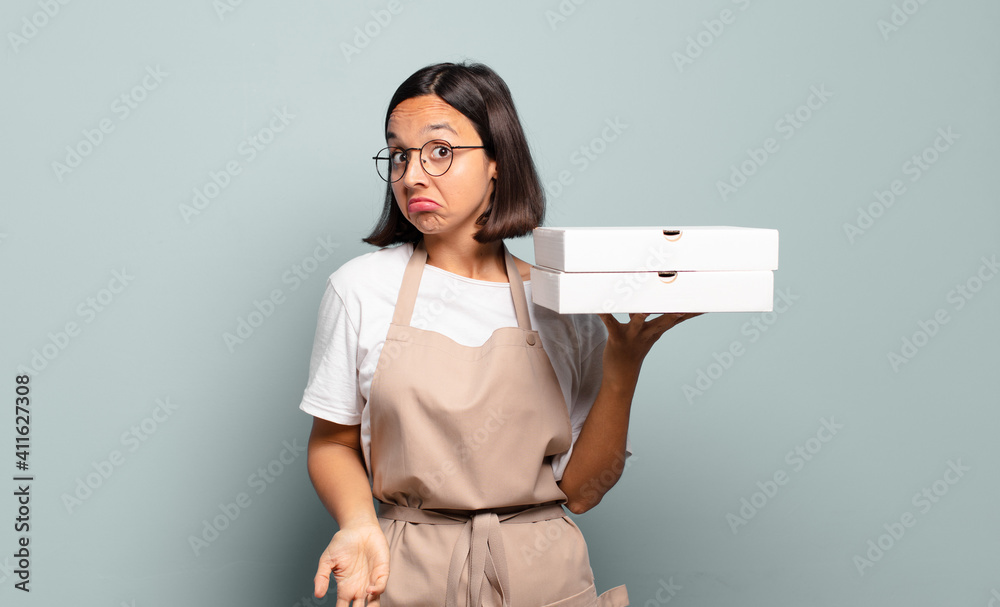 Sticker young hispanic woman shrugging, feeling confused and uncertain, doubting with arms crossed and puzzled look