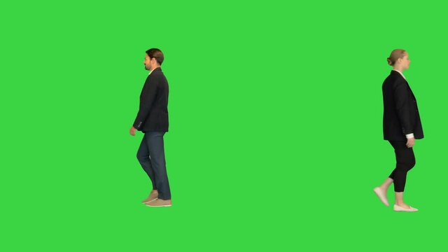 Confident business partners walking passing by each other on a Green Screen, Chroma Key.