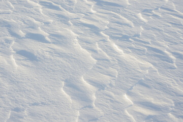 Fresh clean white snow background texture. Winter background with snowflakes and snow mounds. Snow lumps. Seasonal landscape details.