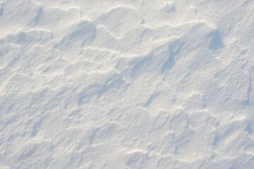 Fresh clean white snow background texture. Winter background with frozen snowflakes and snow mounds. Snow lumps. Seasonal landscape details. Cold weather.