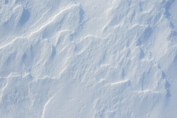 Fresh clean white snow background texture. Winter background with snowflakes and snow mounds. Snow lumps. Seasonal landscape details.