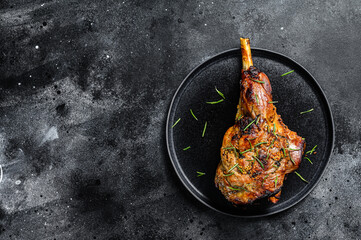 Oven baked lamb leg.  Dark background. Top view. Copy space