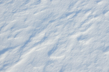 Fresh clean white snow background texture. Winter background with snowflakes and snow mounds. Snow lumps. Seasonal landscape details.