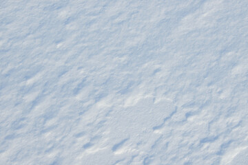 Fresh clean white snow background texture. Winter background with frozen snowflakes and snow mounds. Snow lumps. Seasonal landscape details. Cold weather.