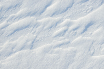 Fresh clean white snow background texture. Winter background with frozen snowflakes and snow mounds. Snow lumps. Seasonal landscape details. Cold weather.