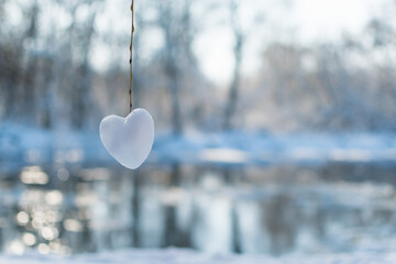 Snow on a tree branch in a heart shape