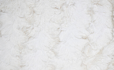 Soft white fur background. Light artificial fur textile material.