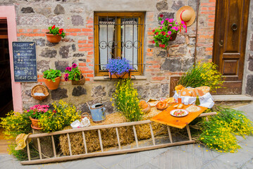 Fototapeta na wymiar Rustic setting with traditional agricultural tools and typical tuscan food, italian countryside 