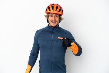 Young blonde cyclist man isolated on white background with surprise facial expression