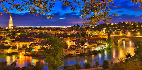 Panorama cityscape of old town of Bern with cathedral tower and Nydeggbr cke bridge illuminated at...