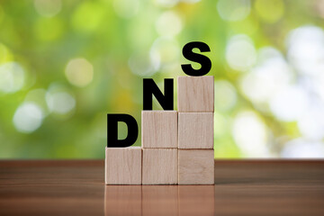DNS  concept of the domain name system on wooden cube background. Network symbol