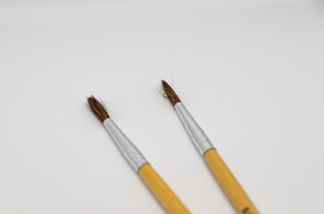 Fototapeta premium Two art brushes for drawing close-ups on a white background.