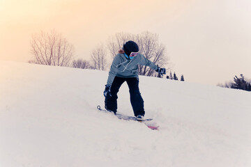 Fototapeta na wymiar Woman riding a snowdeck snowskate snowboard