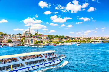 Touristic sightseeing ships in Golden Horn bay of Istanbul and view on Suleymaniye mosque with...