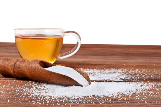 Cup of tea and scoop of sorbitol isolated on a white background. Sweeteners and diet concept.