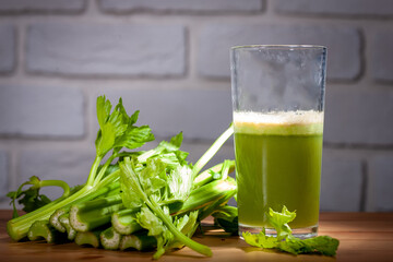 Healthy Celery diet for the treatment of incurable mysterious diseases. Fresh celery juice squeezed out on a juicer.drink, vegetable juice, studio shot