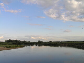 Fototapeta na wymiar clouds over the river