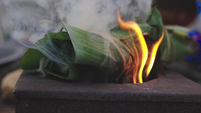 Grilling fish wrapped in banana leaves