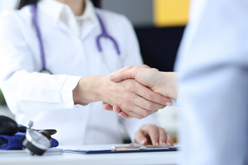 Fototapeta premium Doctor and the patient shake hands closeup