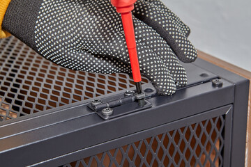 Self-assembly of flat-pack furniture at home.