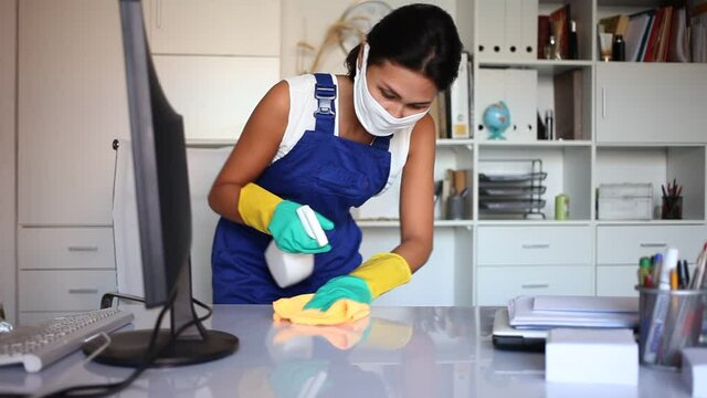 Office cleaner in protective mask is satisfied after cleaning. High quality FullHD footage