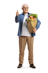 Full length portrait of a mature man with a grocery bag showing thumbs up