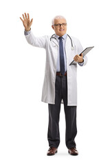 Full length portrait of a mature doctor standing and waving