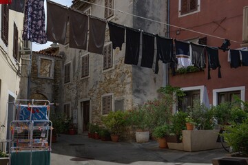 Drying clothes between houses, a typical tradition of Mediterranean streets. Izola, Slovenia