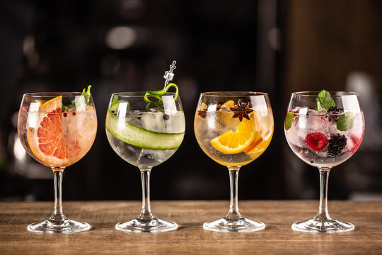 Gin tonic long drink as a classic cocktail in various forms with garnish in individual glasses such as orange, grapefruit, cucumber or berries