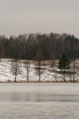 Typical Polish winter landscape. Frozen lake and forest. Selective focus. Rzeck village, Masuria, Poland. 