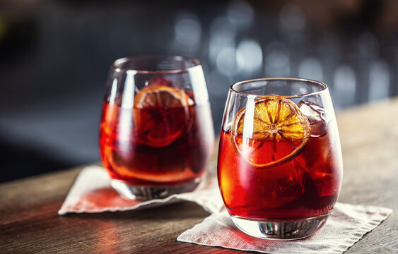 Negroni classic cocktail and gin short drink with sweet vermouth, red bitter liqueur and dried orange garnish