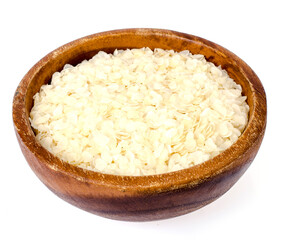 Wooden bowl of flattened rice flakes isolated on white background