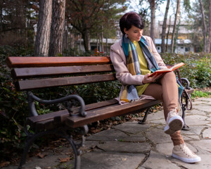 Woman reading a book at the park