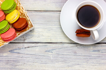 French macaroon cookies and a cup of coffee on the table. Provence style.