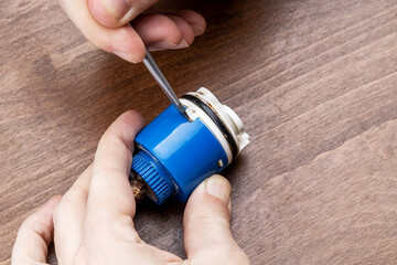 old clogged broken faucet cartridge. handyman repair leaky faucet. water tap fix service concept