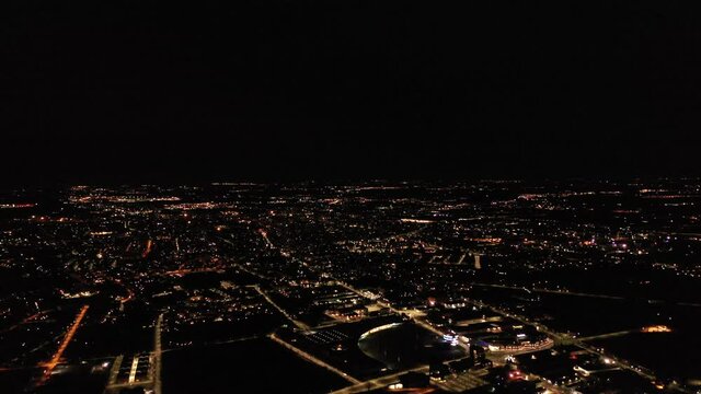 a view from a height of the evening city during the quarantine period, when cars hardly drive and everyone turned on the lights in their houses