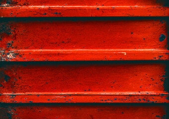 Damaged corrugated metal sheet, weathered rusted steel, grunge background with red painted metal, textured surface, outdoors.