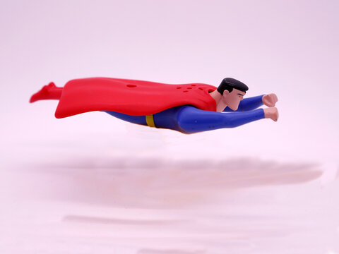 Superman flying with his cape between the nuts. Superman Super Hero. Toy figure. Toy. Classic super hero who flies. Marvel. DC comics. Planet Krypton. Kryptonite.