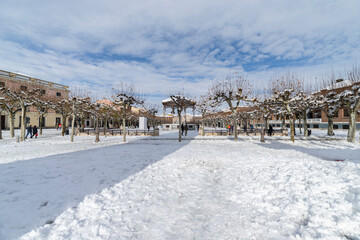 Cervantes square in the city of alcala de henares covered in snow