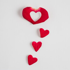 Heart made on a rose petal on a white background. champagne. Valentines or woman's day creative concept. Minimal flat lay.